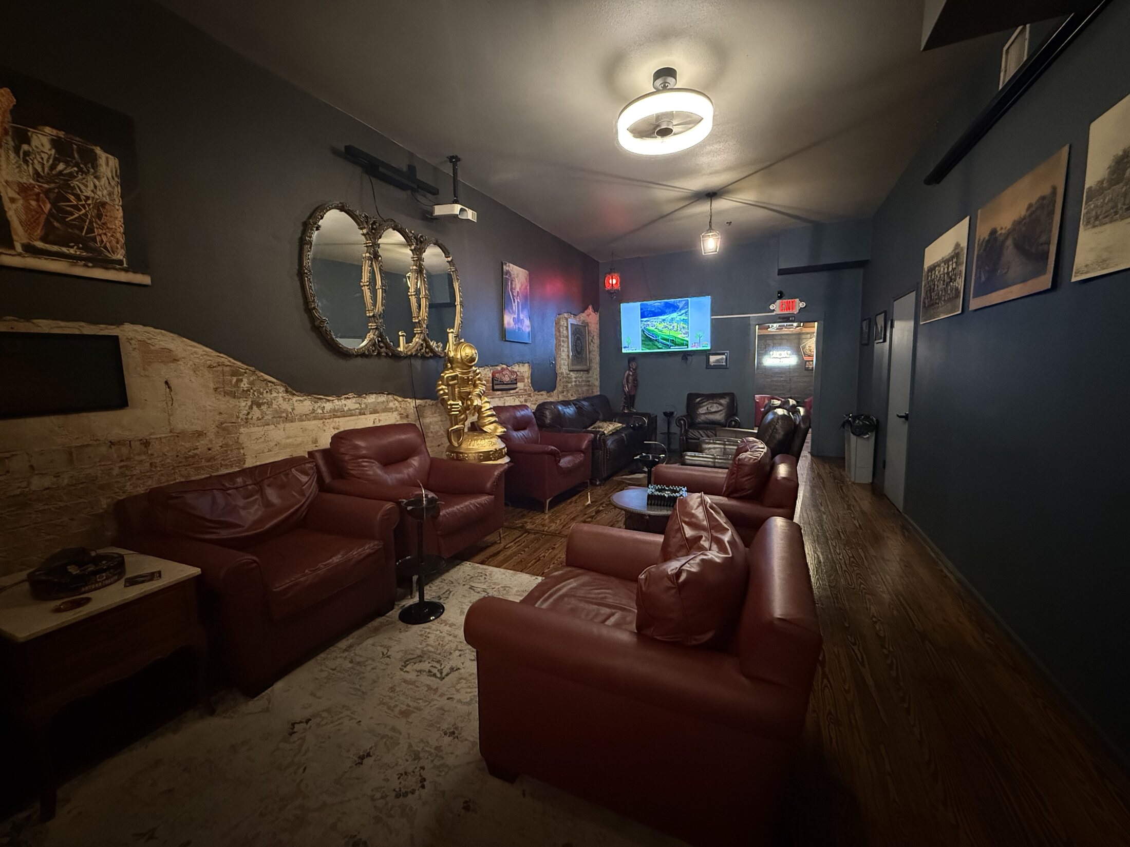 Oxblood leather chairs, exposed brick, and warm lamplight inside the lounge